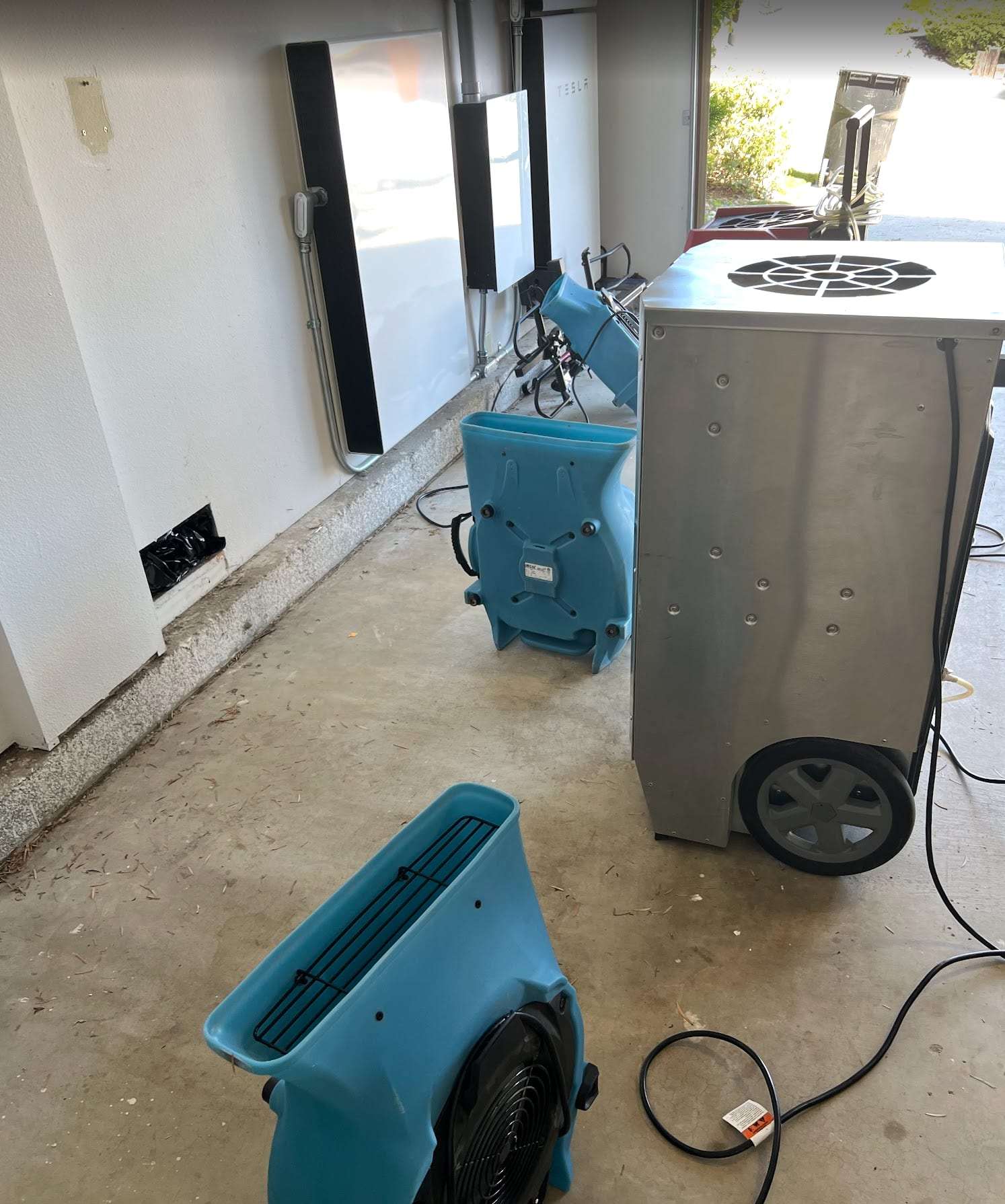 Garage drying setup with air movers and a dehumidifier